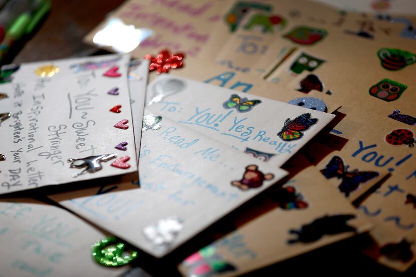 Cards that Angela Joy Bailey wrote sit on the table at her grandparents' home in Bedford,...