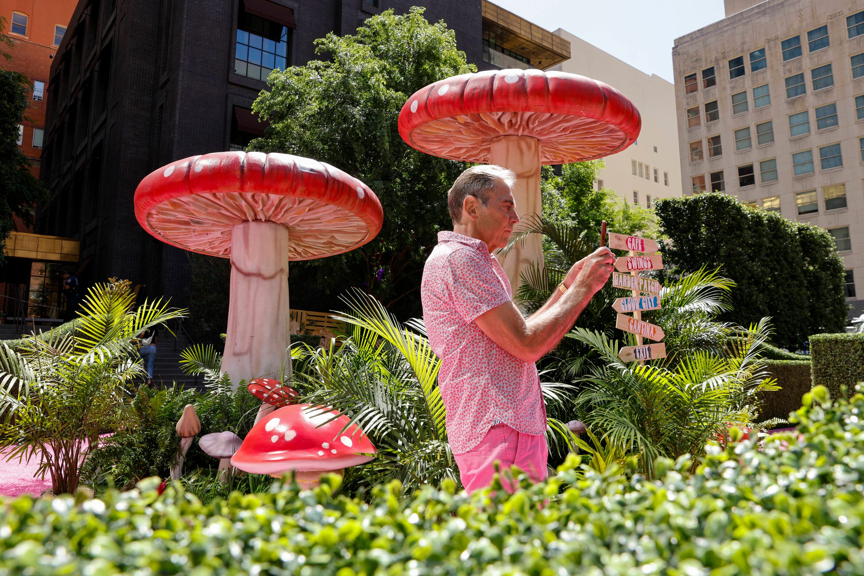 Cleve Schneider of Dallas talks photos as he walks around the Eyeboretum on Friday.