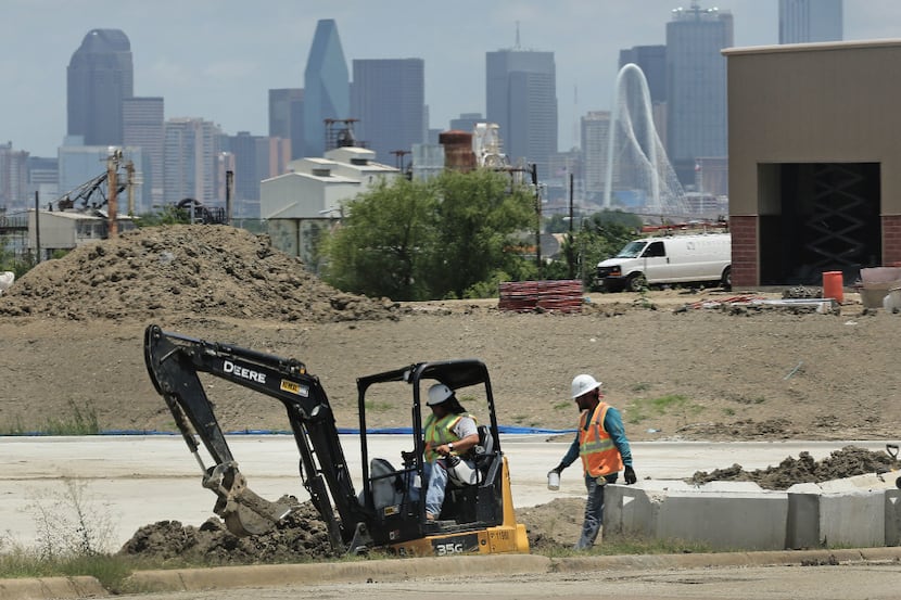 Downtown Dallas looms in the background of a construction project near Hampton Road in West...