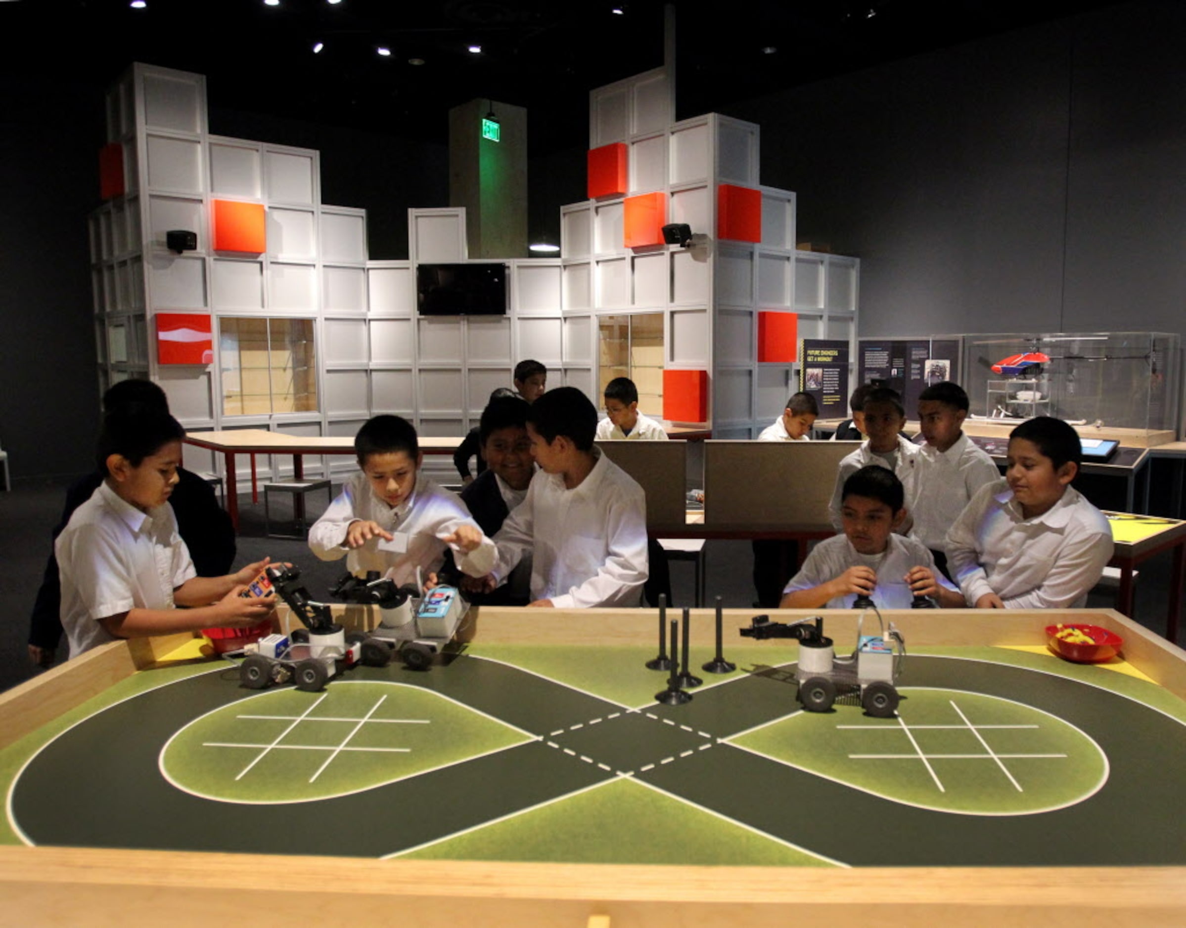 Kids play in the Robot Arena, where they can design, build and program robots, at the Perot...