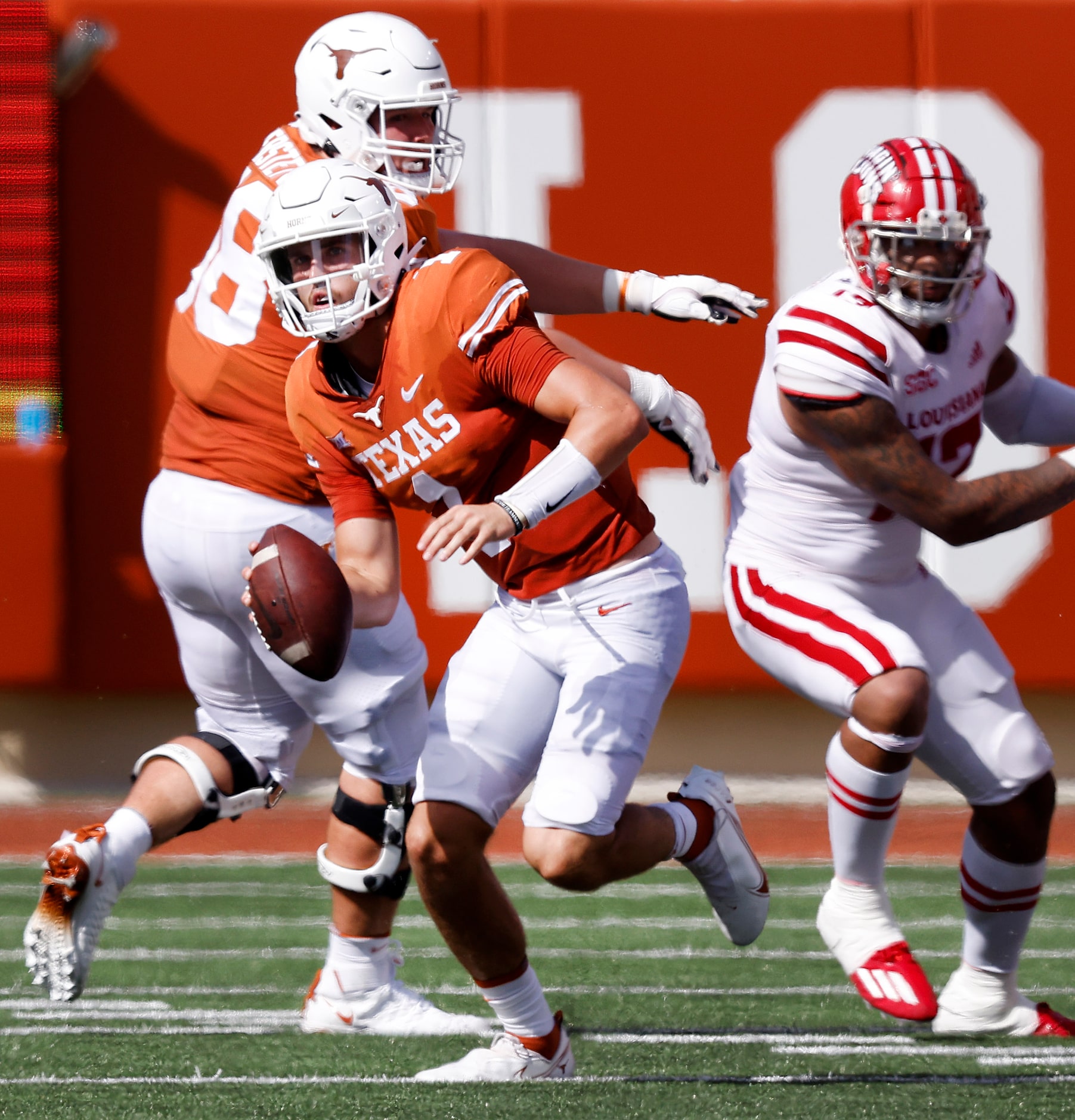 Texas Longhorns quarterback Hudson Card (1) rolls out against the Louisiana-Lafayette Ragin...