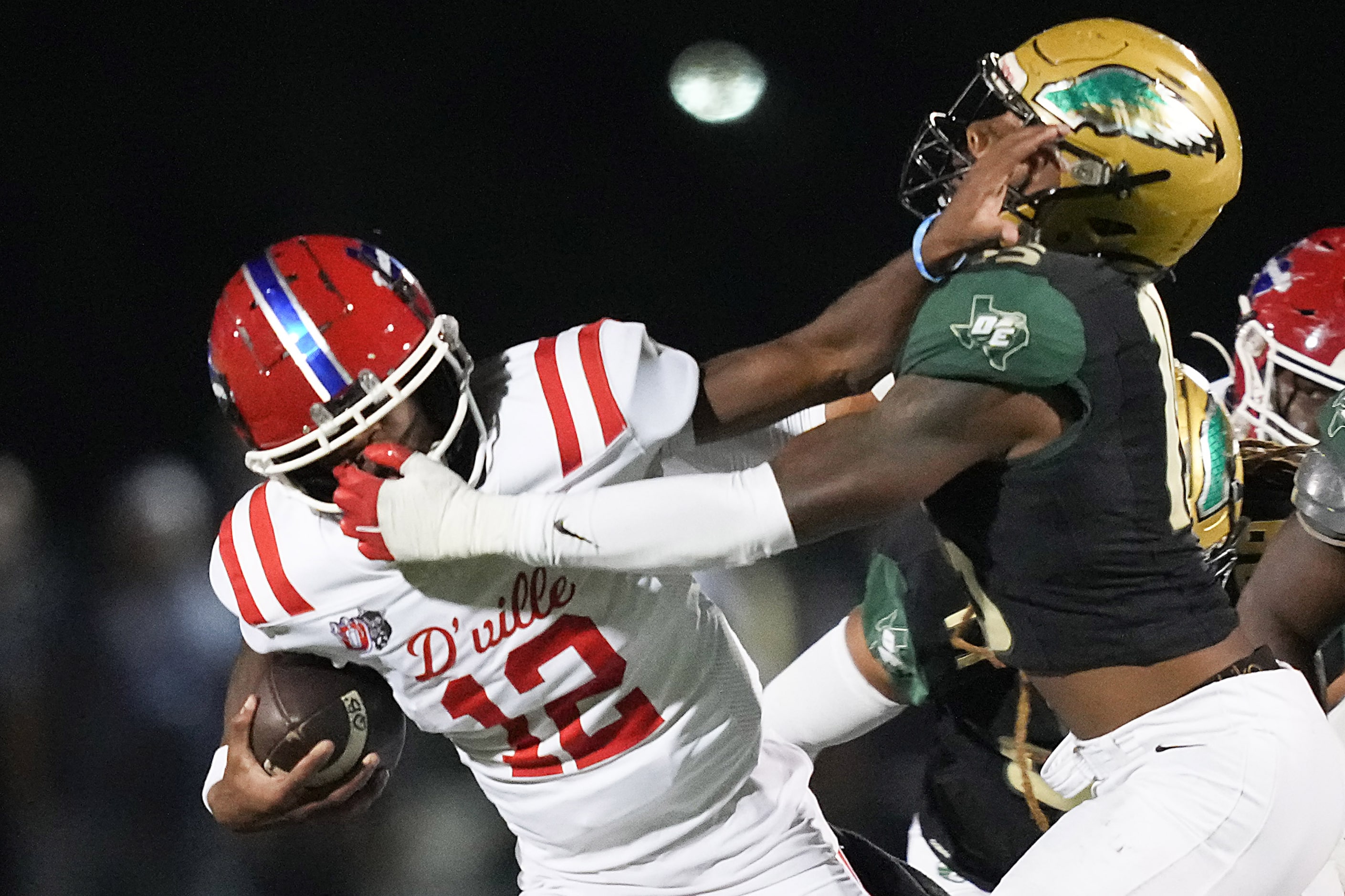 Duncanville quarterback Keelon Russell (12) is brought down by DeSoto defensive lineman...