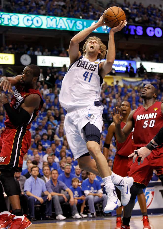 Dallas Mavericks power forward Dirk Nowitzki (41) splits Miami Heat shooting guard Dwyane...