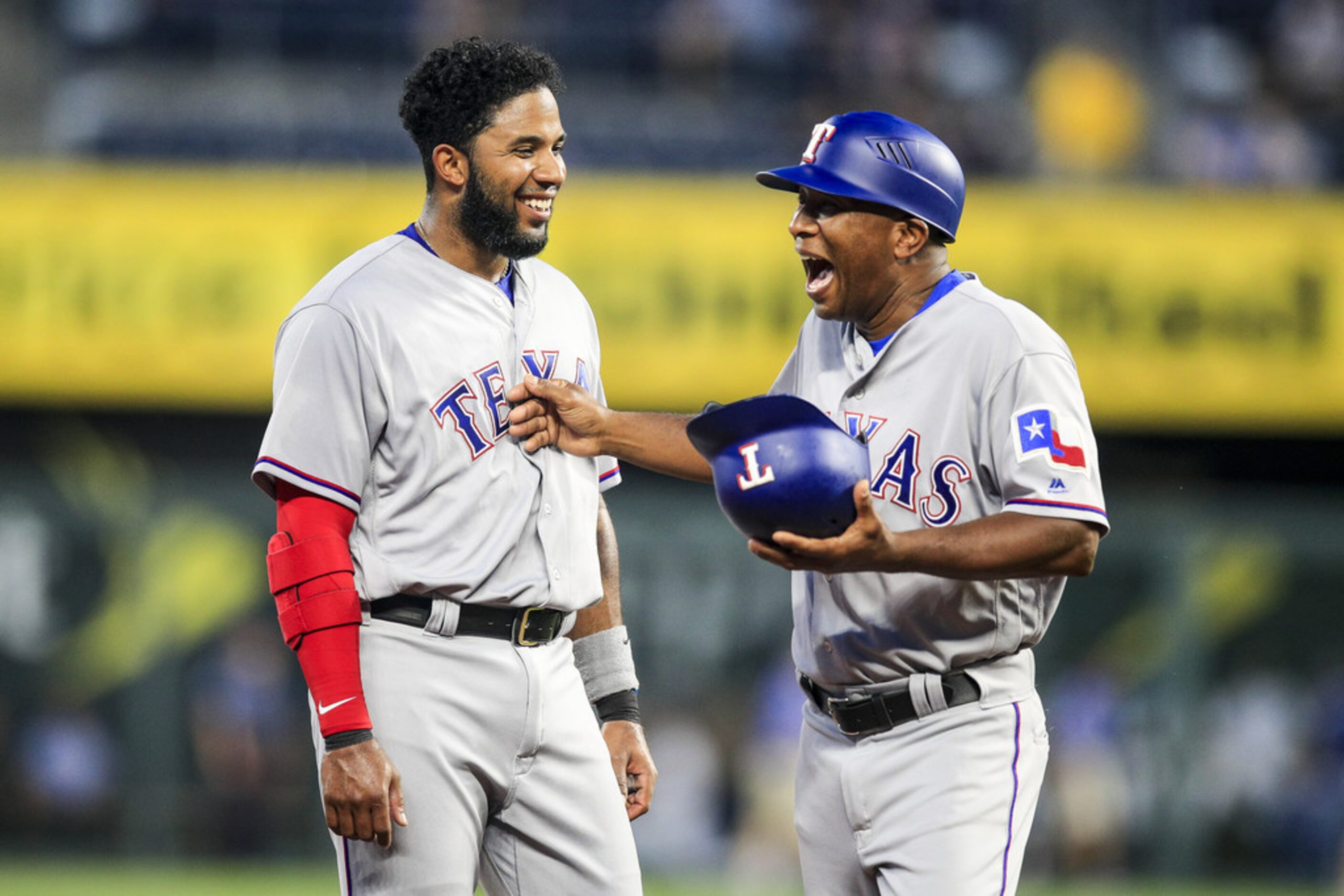 KANSAS CITY, MO - JUNE 18: Elvis Andrus #1 and Tony Beasley #27 of the Texas Rangers share a...