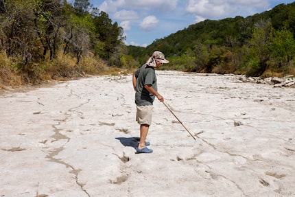 Dinosaur track researcher Glen Kuban pointed out various dinosaur tracks in the Paluxy River...