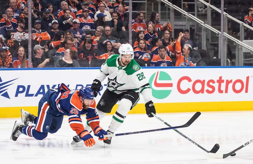Dallas Stars' Alexander Petrovic (28) and Edmonton Oilers' Connor Brown (28) battle for the...