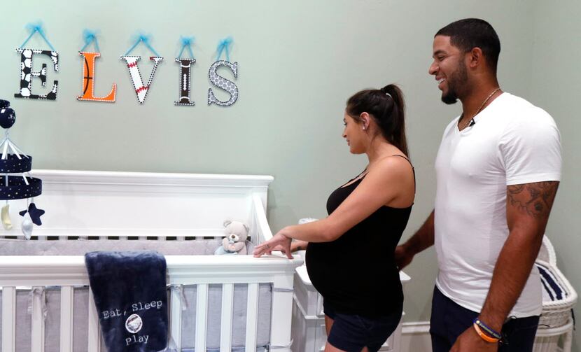 Texas Rangers shortstop Elvis Andrus and his wife Cori Andrus Febles, look at a new crib in...