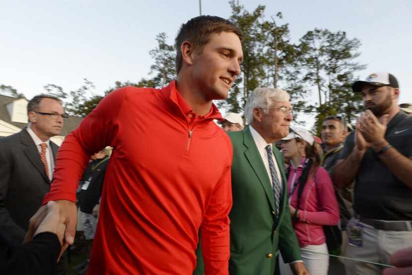 Bryson DeChambeau walks to the green jacket ceremony after the final round of the 2016 The...