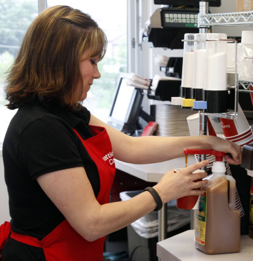 Valarie Floyd prepares a drink in the Skillman store ahead of Monday's opening.