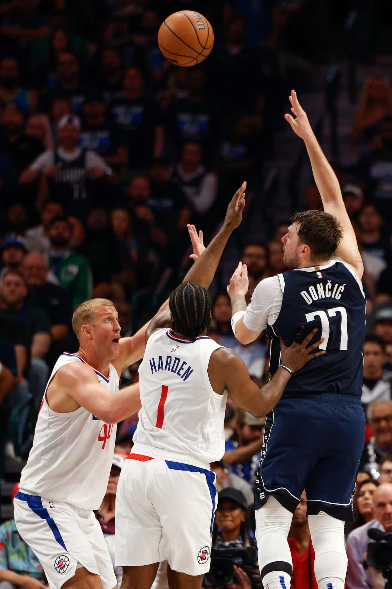 Dallas Mavericks guard Luka Doncic (77) floats a shot over LA Clippers guard James Harden...