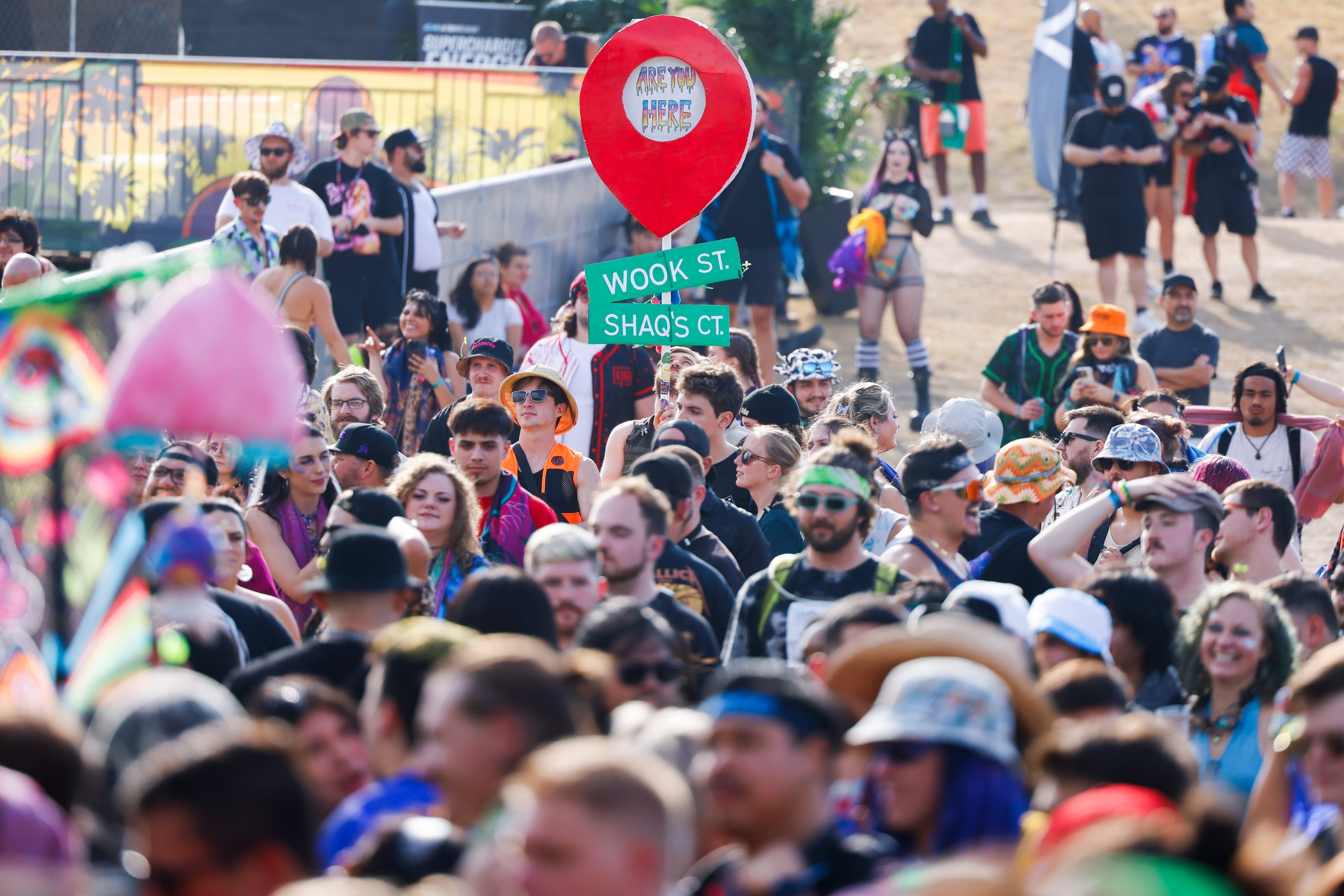 Attendees display signs as they wait for Shaquille O’Neal’s DJ performance during Shaq’s...