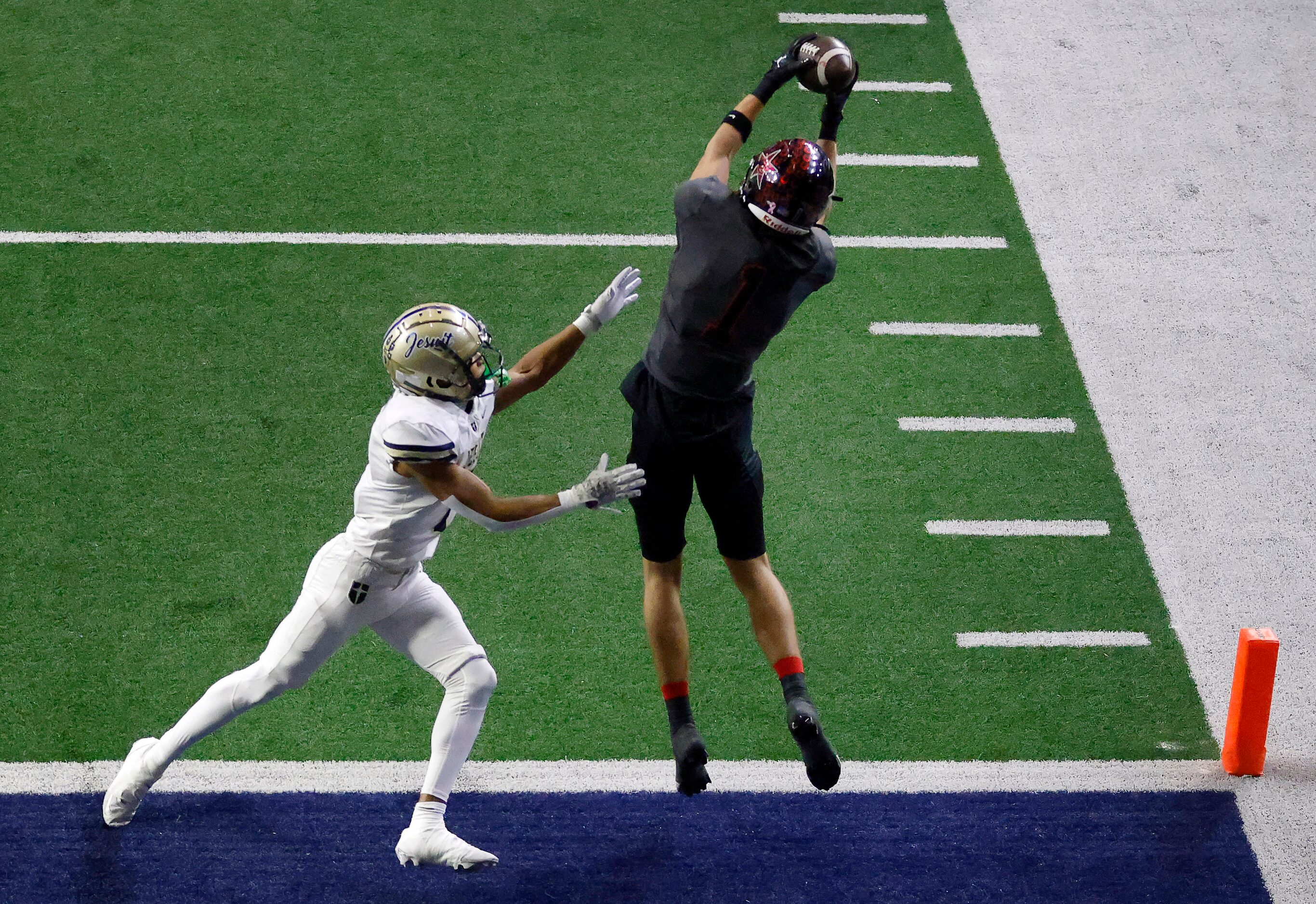 Coppell running back Baron Tipton (1) leaps for a first quarter touchdown against Jesuit...