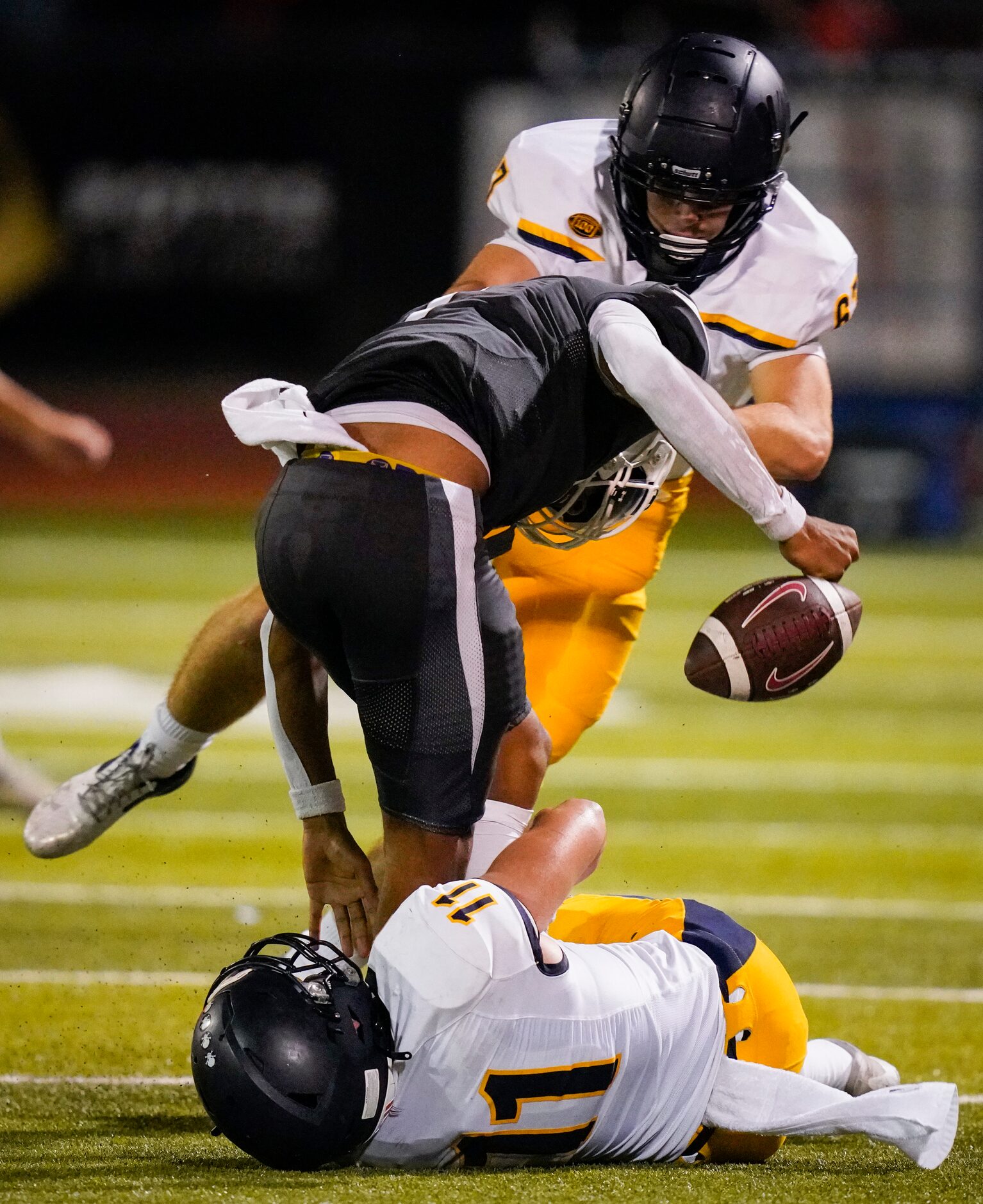 Lewisville quarterback  Ethan Terrell (7) loses the football as he is hit by Highland Park...