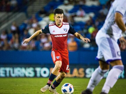 Dallas midfielder Pablo Aranguiz (10) dribbles the ball up the field during the soccer game...