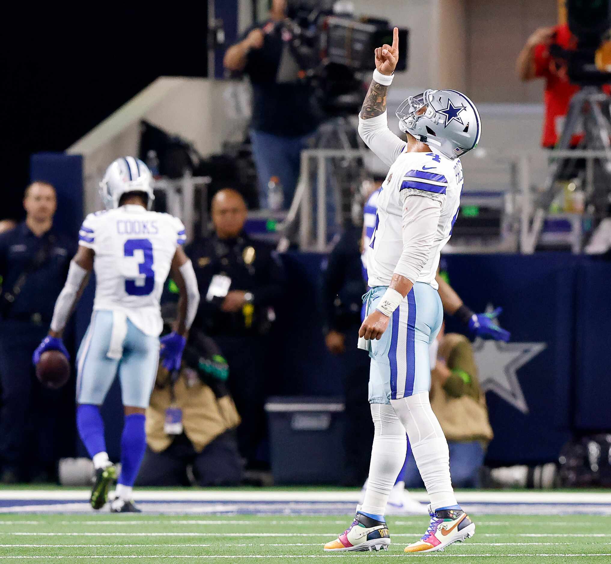 Dallas Cowboys quarterback Dak Prescott (4) points skyward after throwing a touchdown pass...