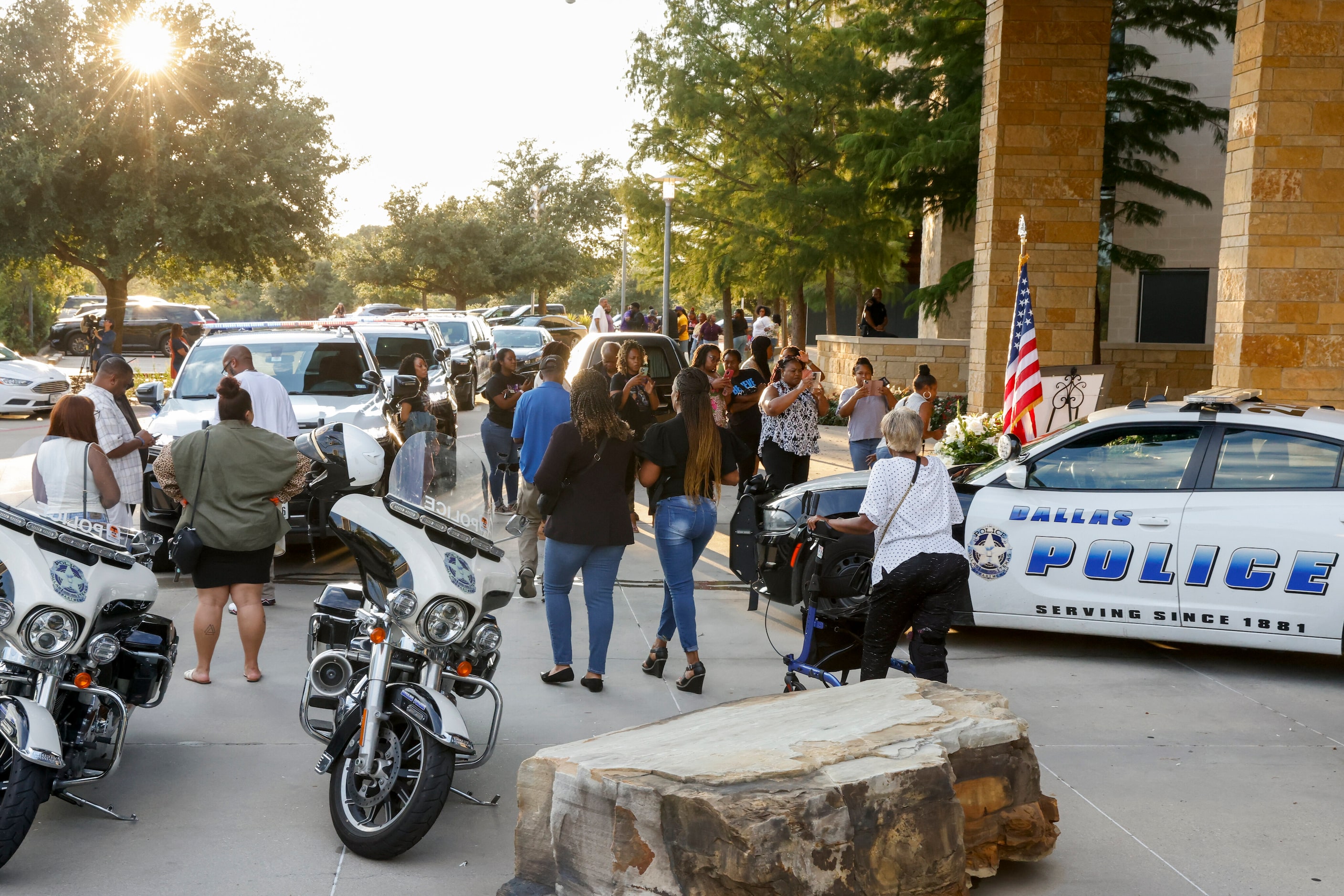 People gather outside during a public visitation for Dallas police Officer Darron Burks at...