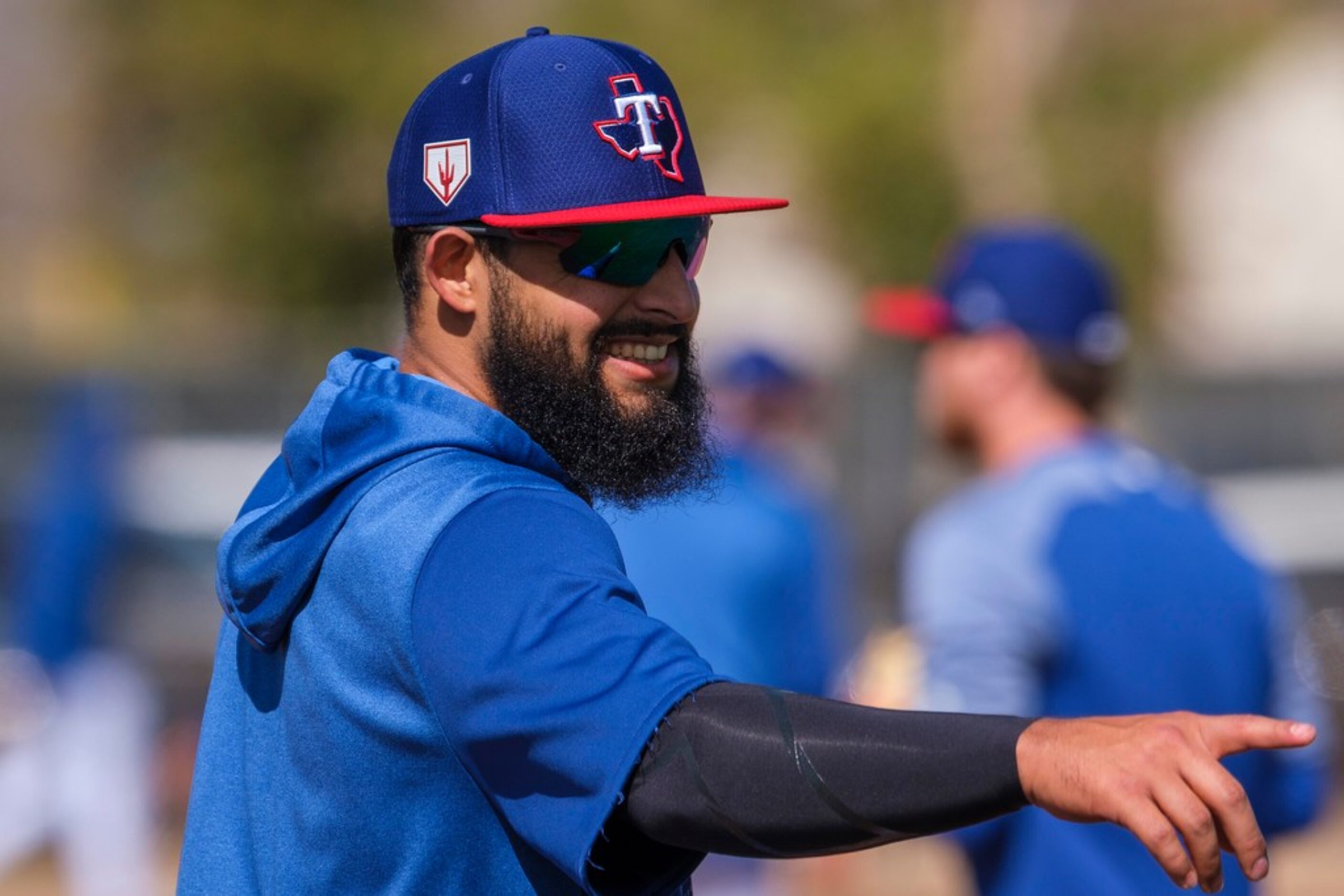 Texas Rangers infielder Rougned Odor laughs with teammates during the first full squad...