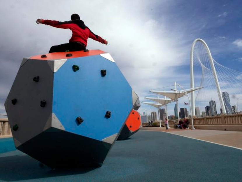 
Kingdom Bankston, 13, raises his arms in victory after conquering a climbing cube in the...