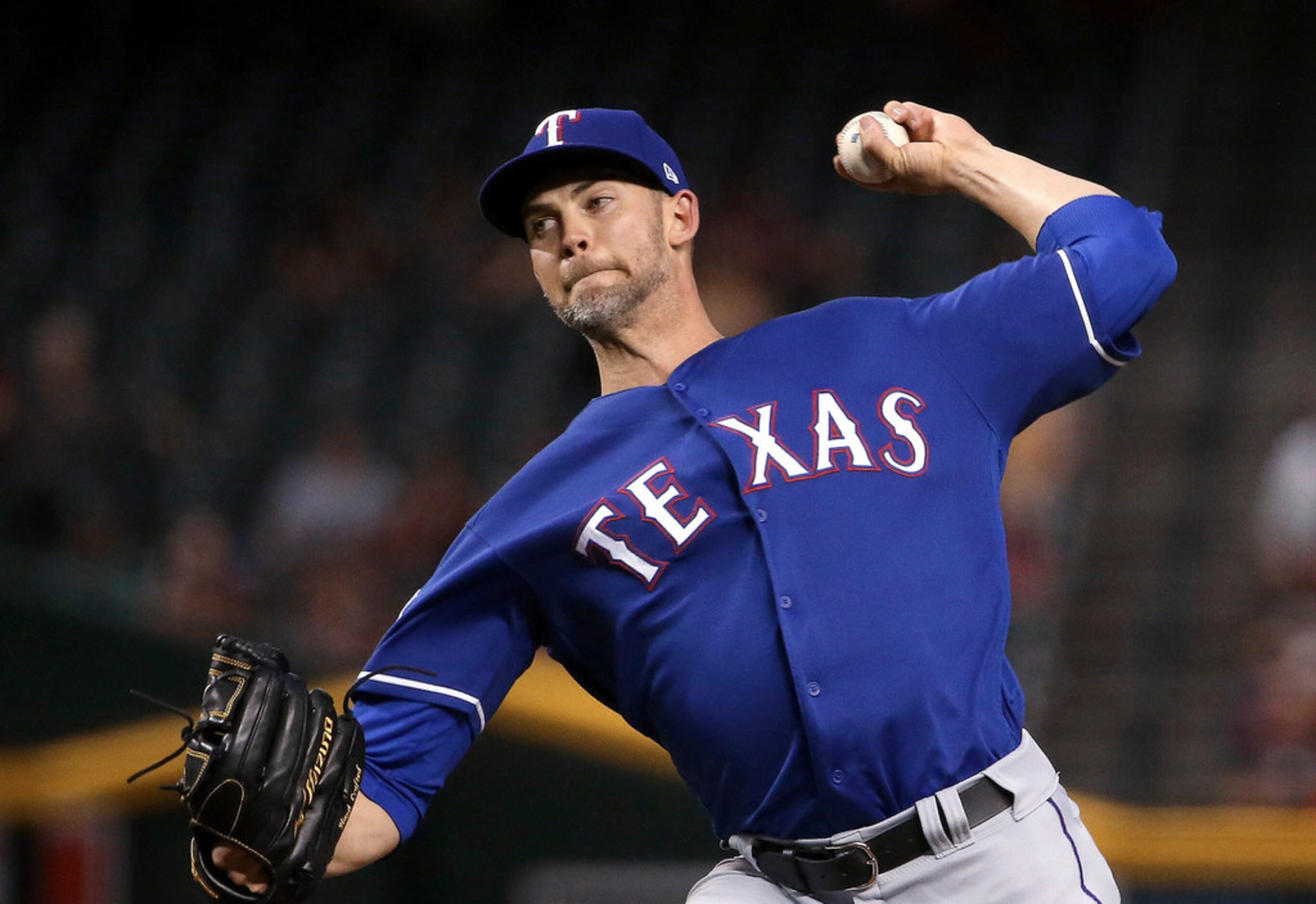 Texas Rangers starting pitcher Mike Minor throws to an Arizona Diamondbacks batter during...