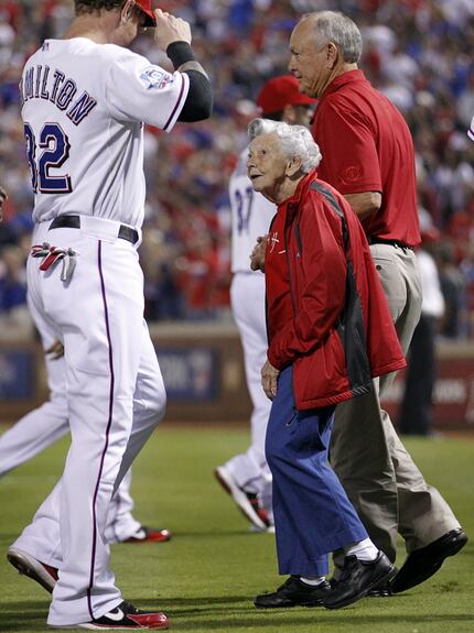 Sister Frances Evans looks up to Texas Ranger Josh Hamilton before throwing out the...