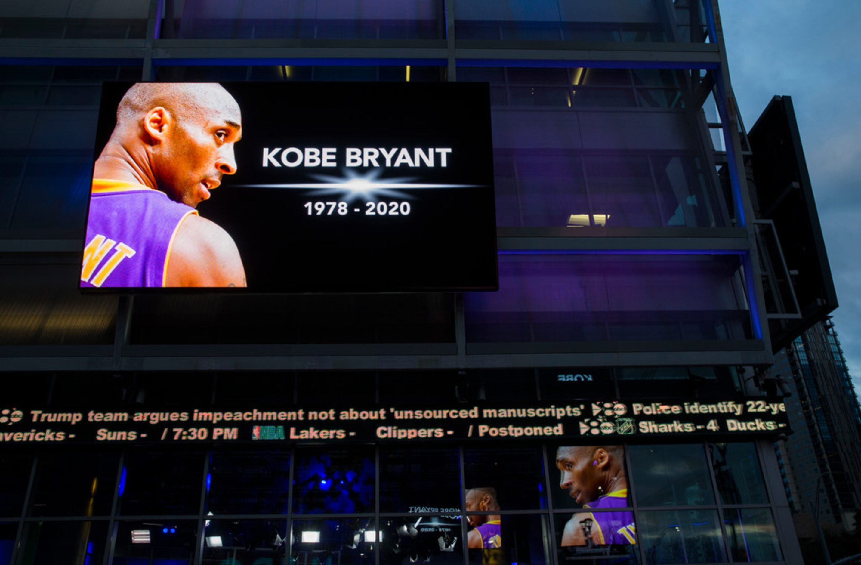 Large screens display a tribute to former Los Angeles Laker Kobe Bryant and his daughter,...