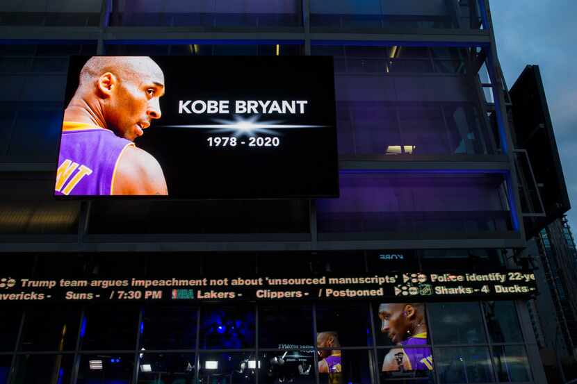 Large screens display a tribute to former Los Angeles Laker Kobe Bryant and his daughter,...