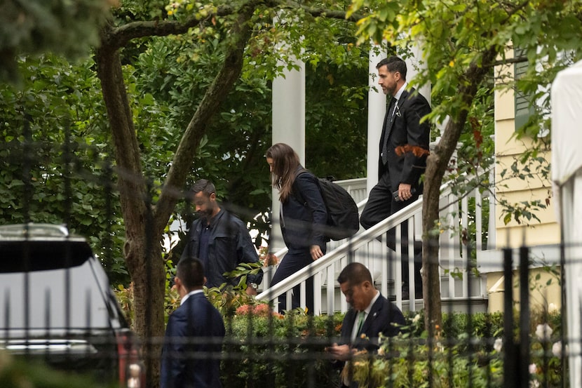 People exit Gracie Mansion, the official residence of New York City Mayor Eric Adams,...