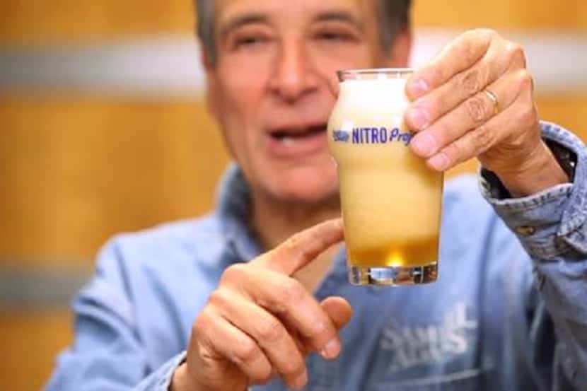 Boston Beer Co. founder Kim Koch demonstrates what happens when a canned nitro beer is...