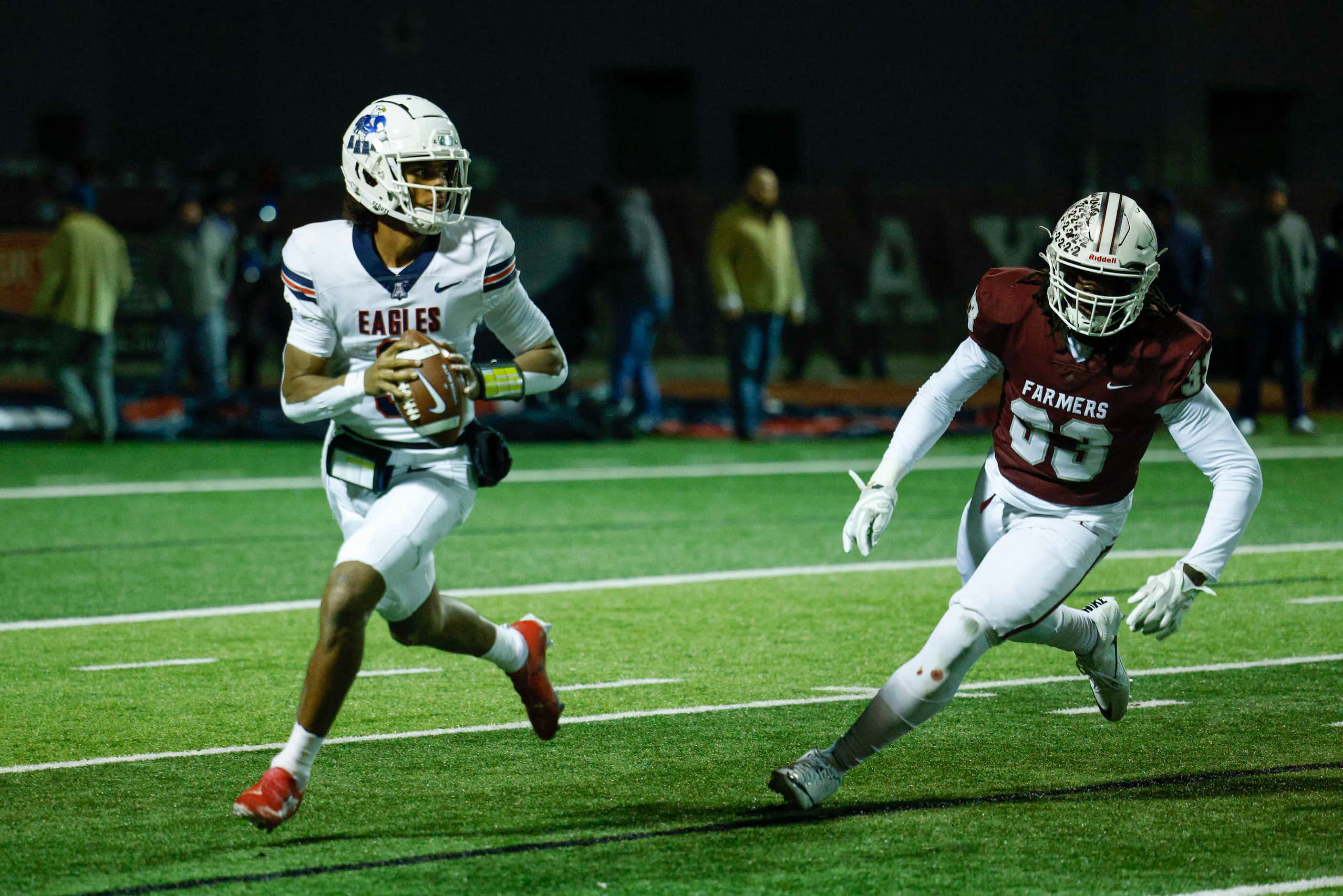 Allen quarterback Mike Hawkins (3) looks to pass the ball ahead of a rushing Lewisville...