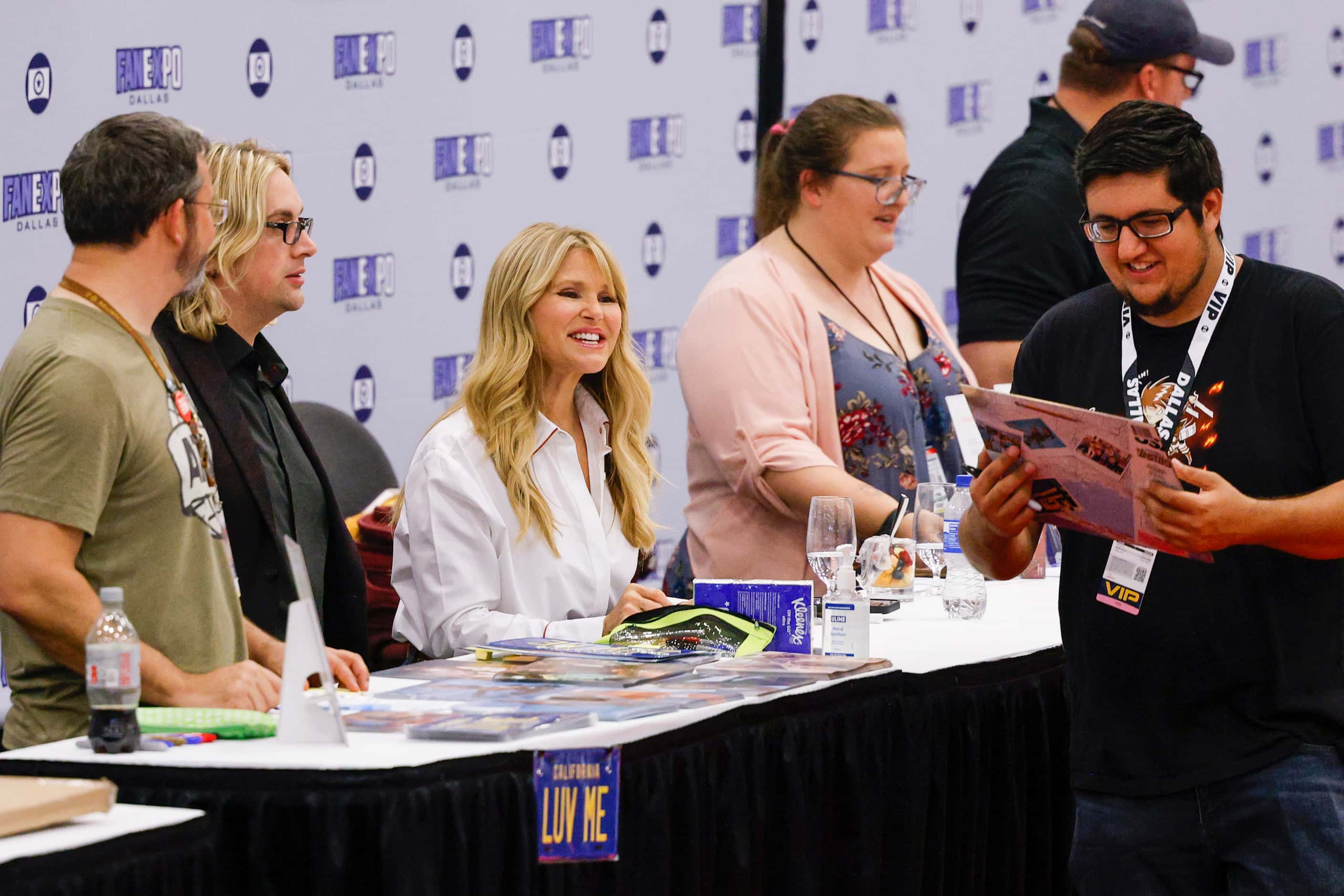 Model and actress Christie Brinkley (center) smiles as she greets fans at Fan Expo Dallas at...