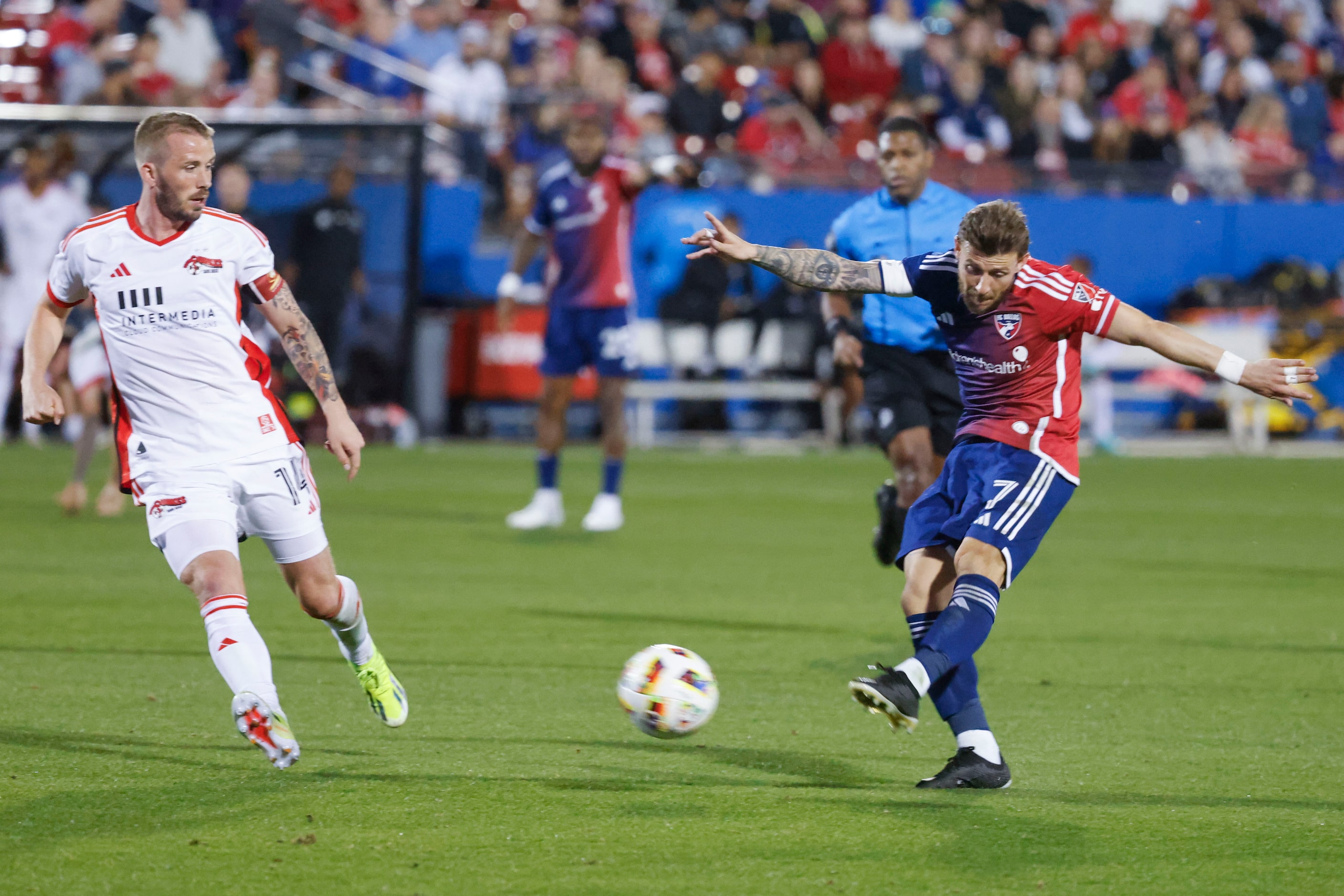 San Jose midfielder Jackson Yueill (left) attempt to block a cross of FC Dallas forward Paul...