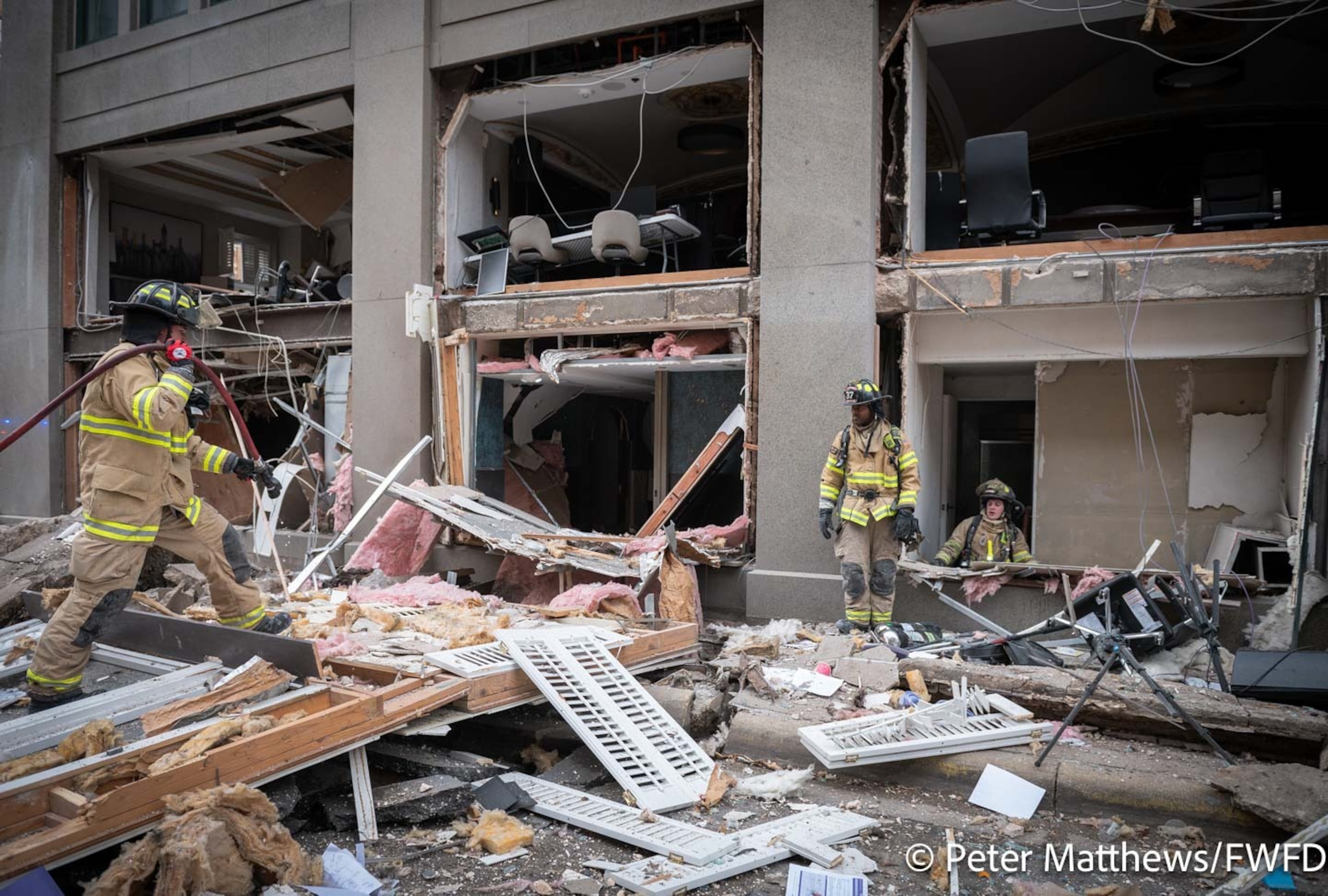 Fort Worth firefighters respond to an explosion at the Sandman Signature Hotel building in...