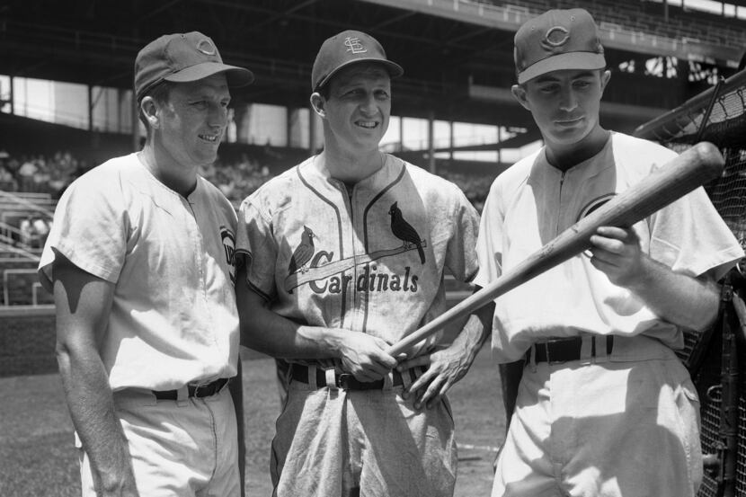 Stan Musial, center, of the St. Louis Cards, checks a bat with Ralph Kiner, left, Chicago...