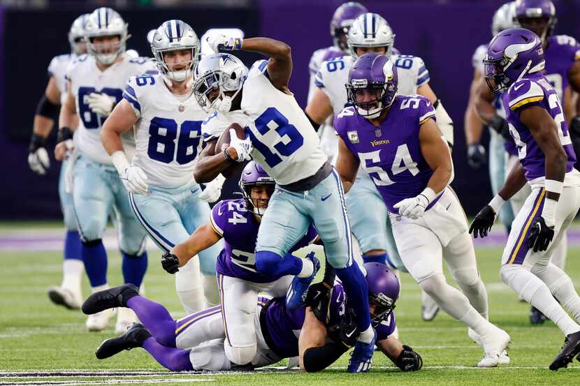 Dallas Cowboys wide receiver Michael Gallup (13) escapes several tackle attempts after...