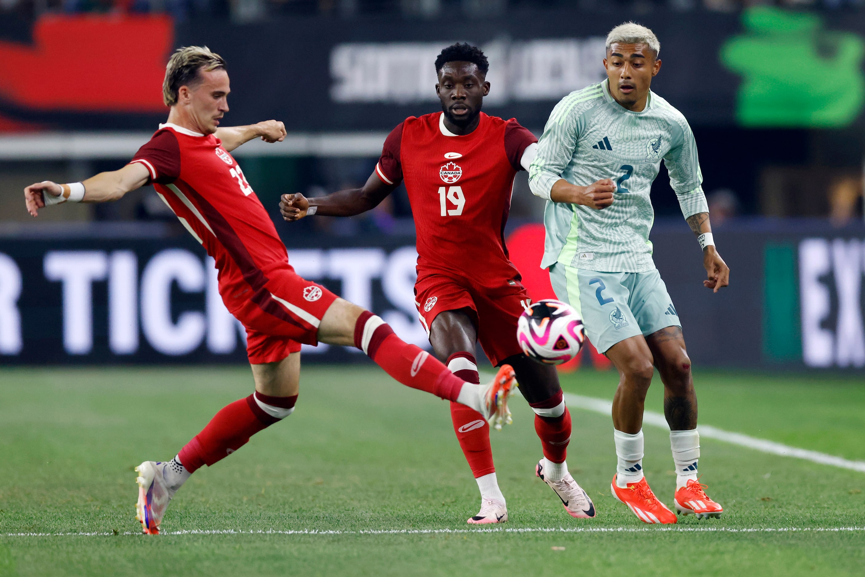 Canada midfielder Liam Millar (23) kicks the ball out of bounds ahead of defenseman Alphonso...