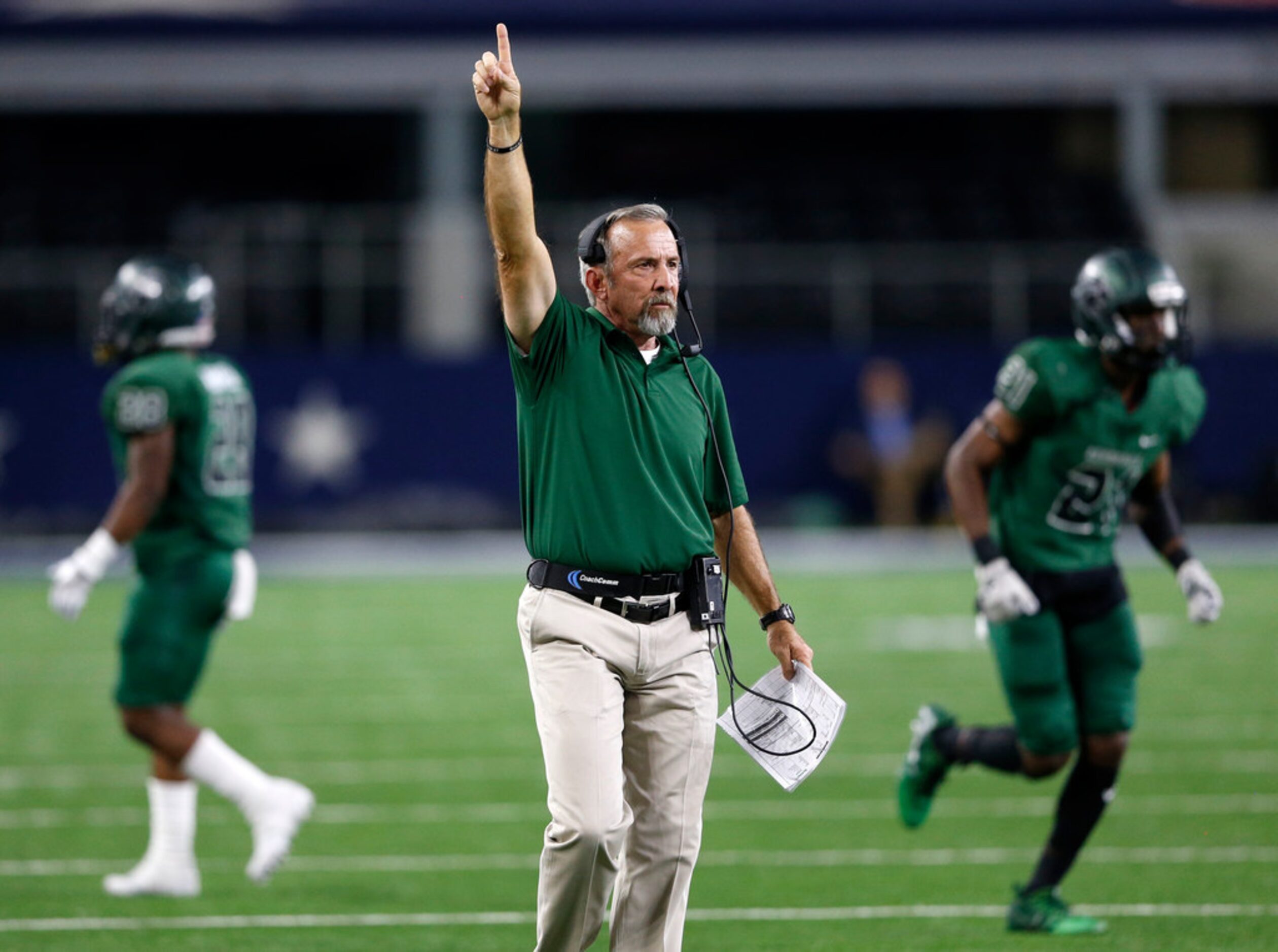 Kennedale's head coach Richard Barrett signals going for one on the point after touchdown...