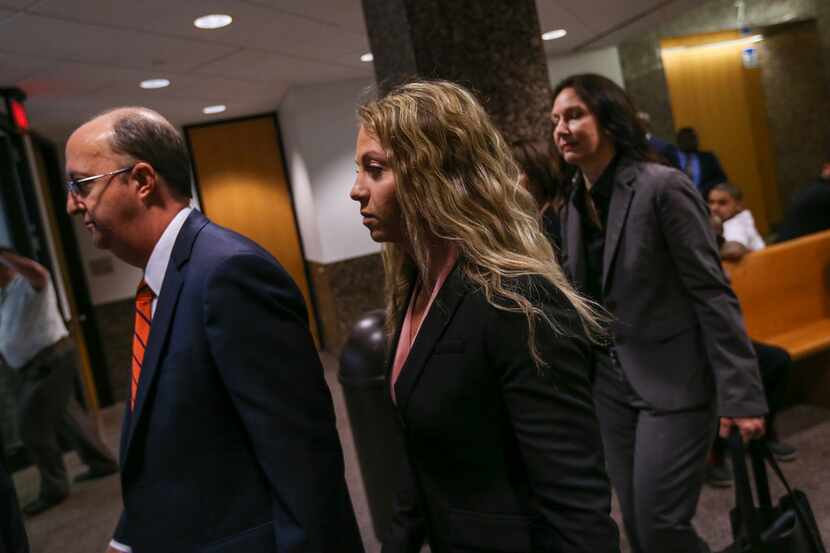 Former Dallas police Officer Amber Guyger (left) departs with her attorneys after making a...