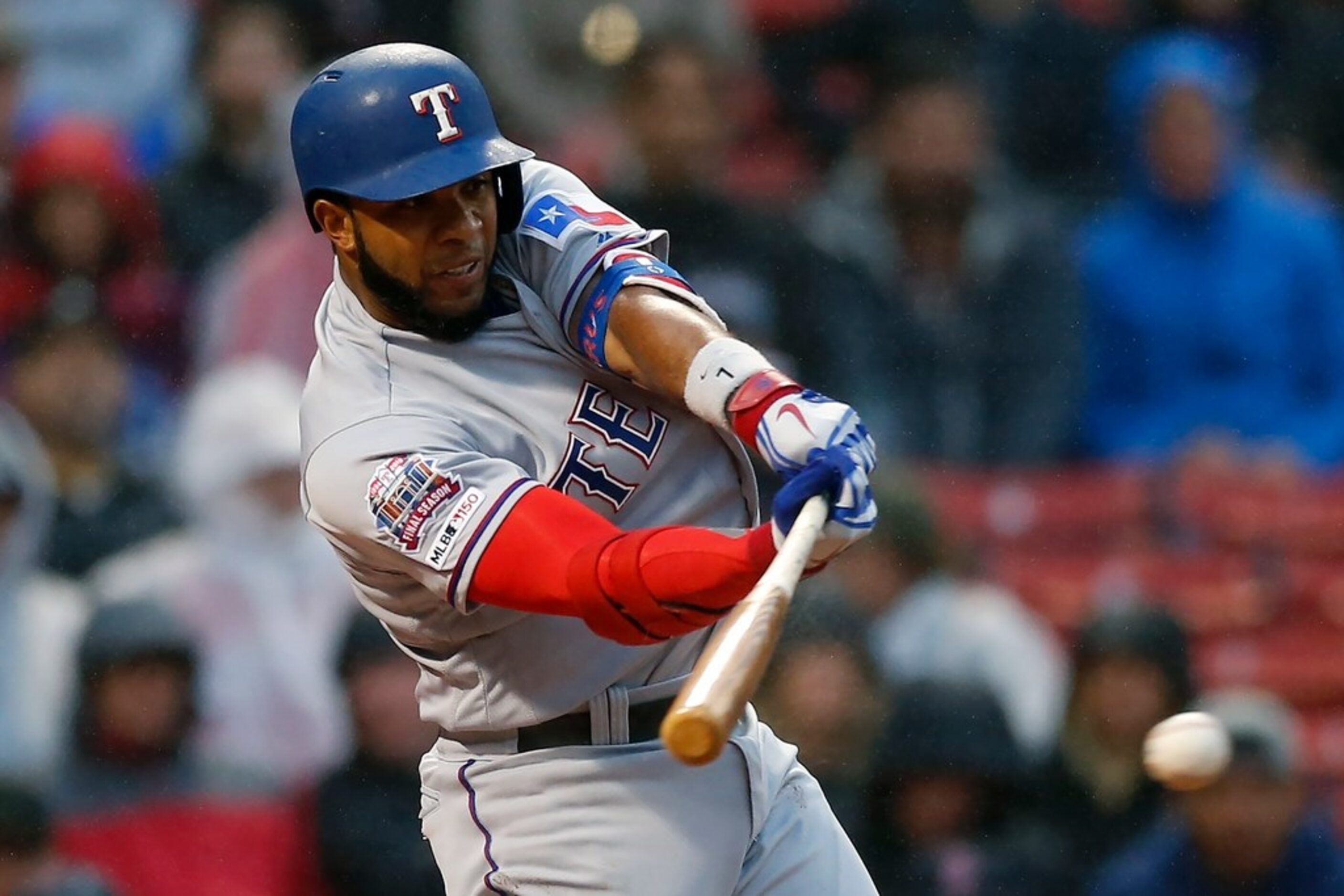 Texas Rangers' Elvis Andrus hits an RBI single during the first inning of a baseball game...