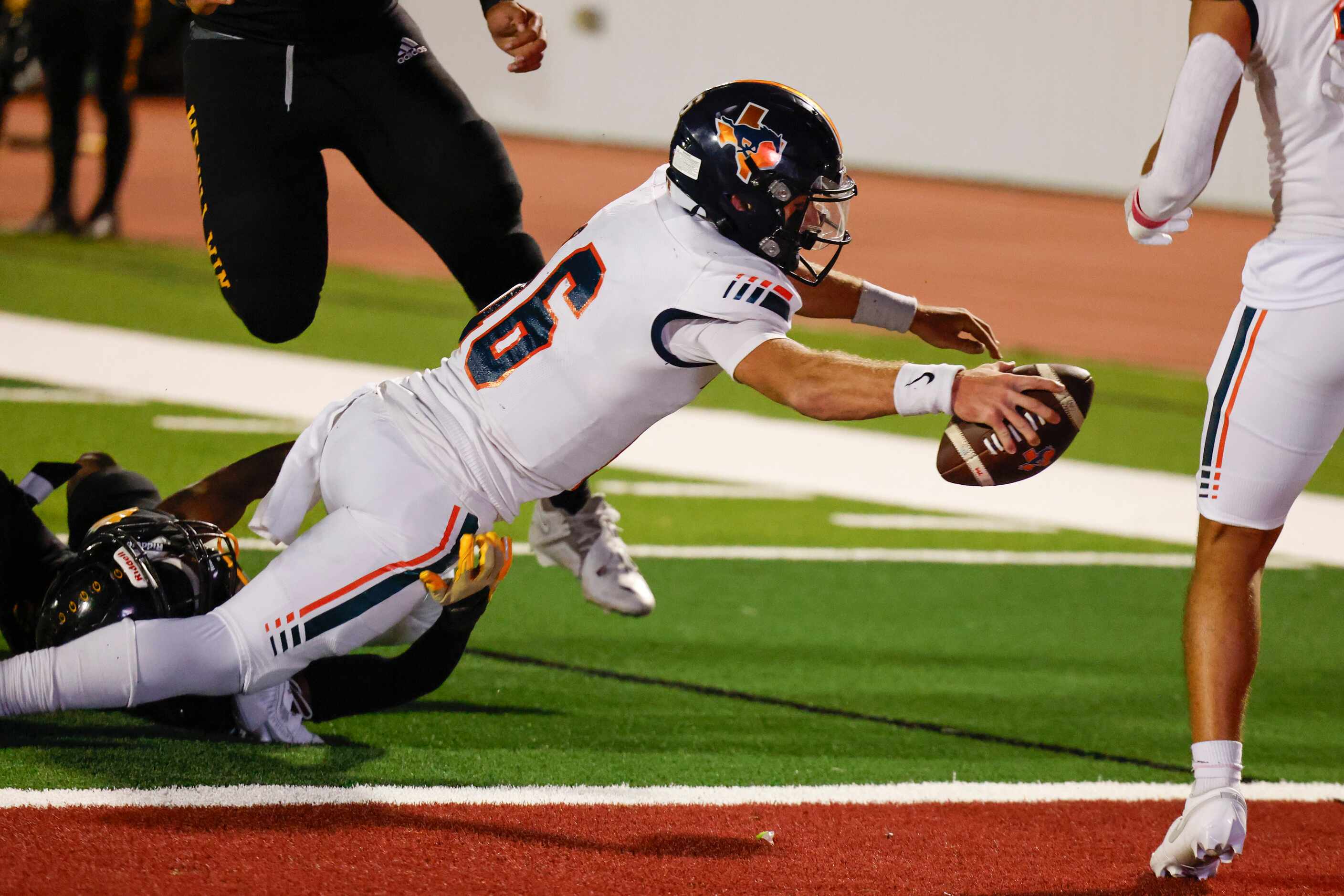Sachse High School QB Brenden George reaches to score a touchdown during the second half of...