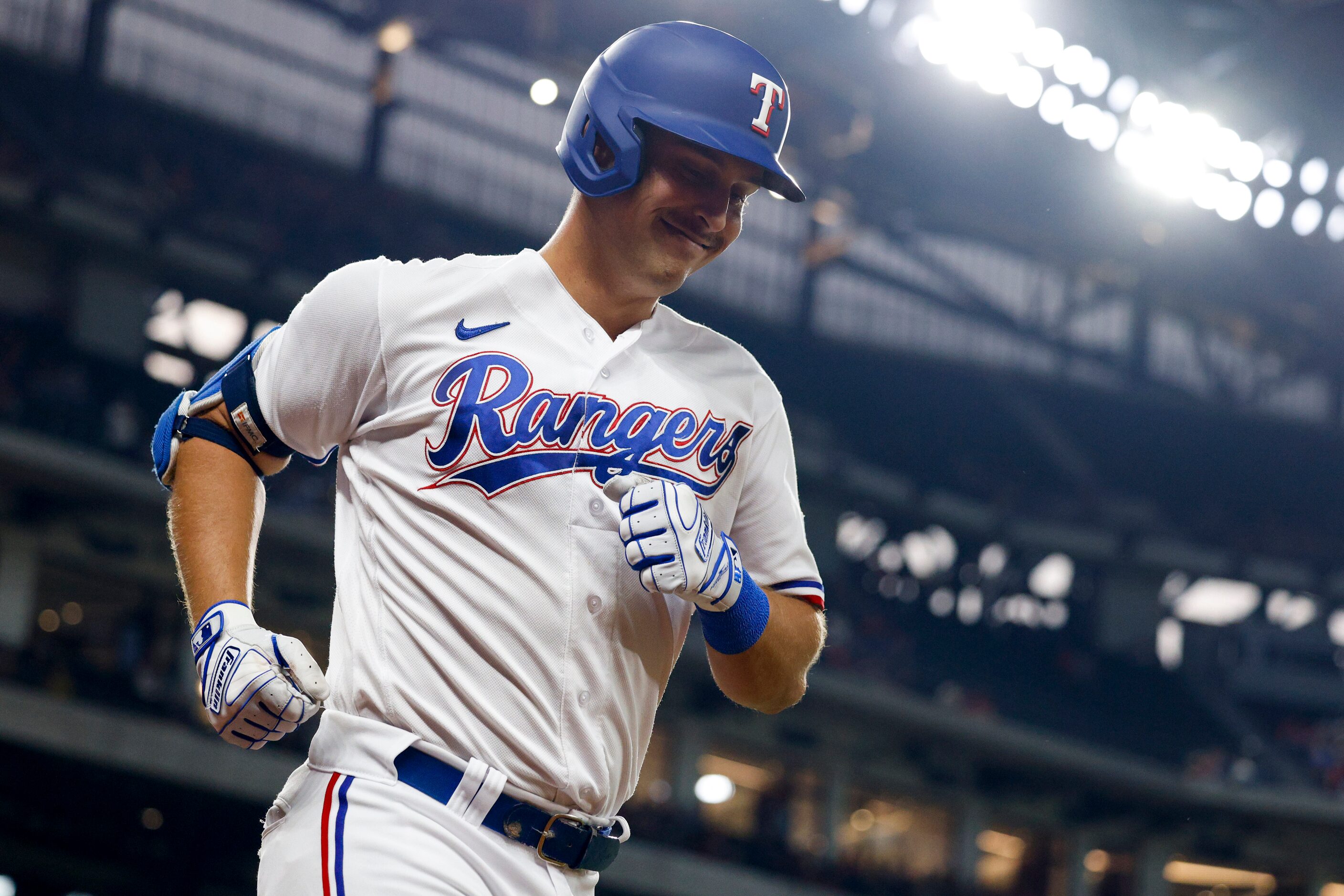 Texas Rangers first baseman Nathaniel Lowe (30) smiles after hitting a two run home run...