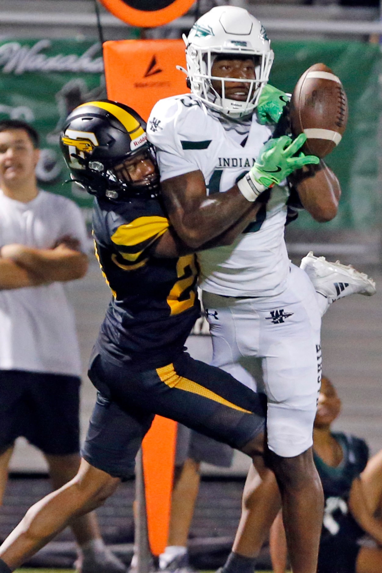 Forney high’s Nolyn Williams (23) dislodges a pass from Waxahachie receiver Tristian Gardner...