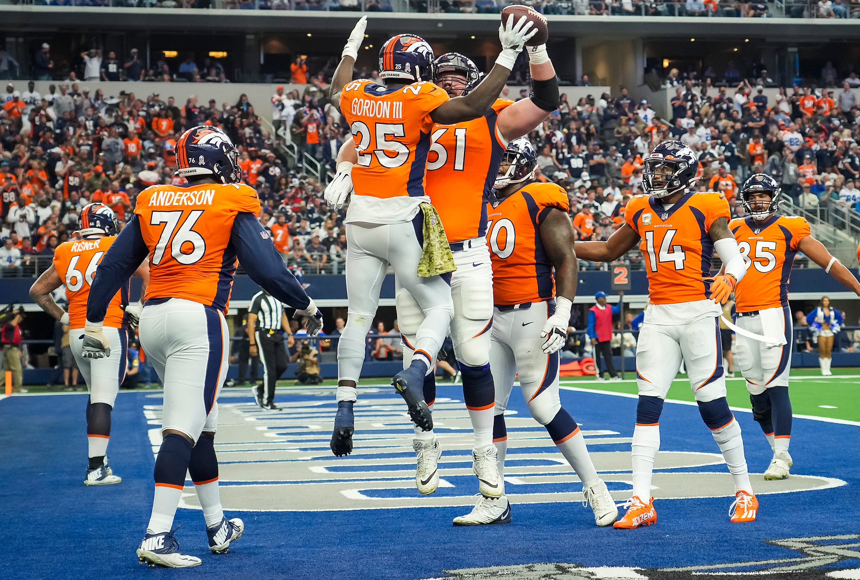 Denver Broncos running back Melvin Gordon (25) celebrates with guard Graham Glasgow (61)...