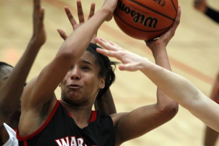 Arlington Martin's Lexis Weber goes for a shot over Flower Mound Marcus during the Mansfield...