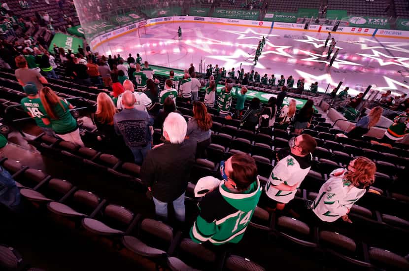 Dallas Stars fans stand for the national anthem during the last home game of the regular...
