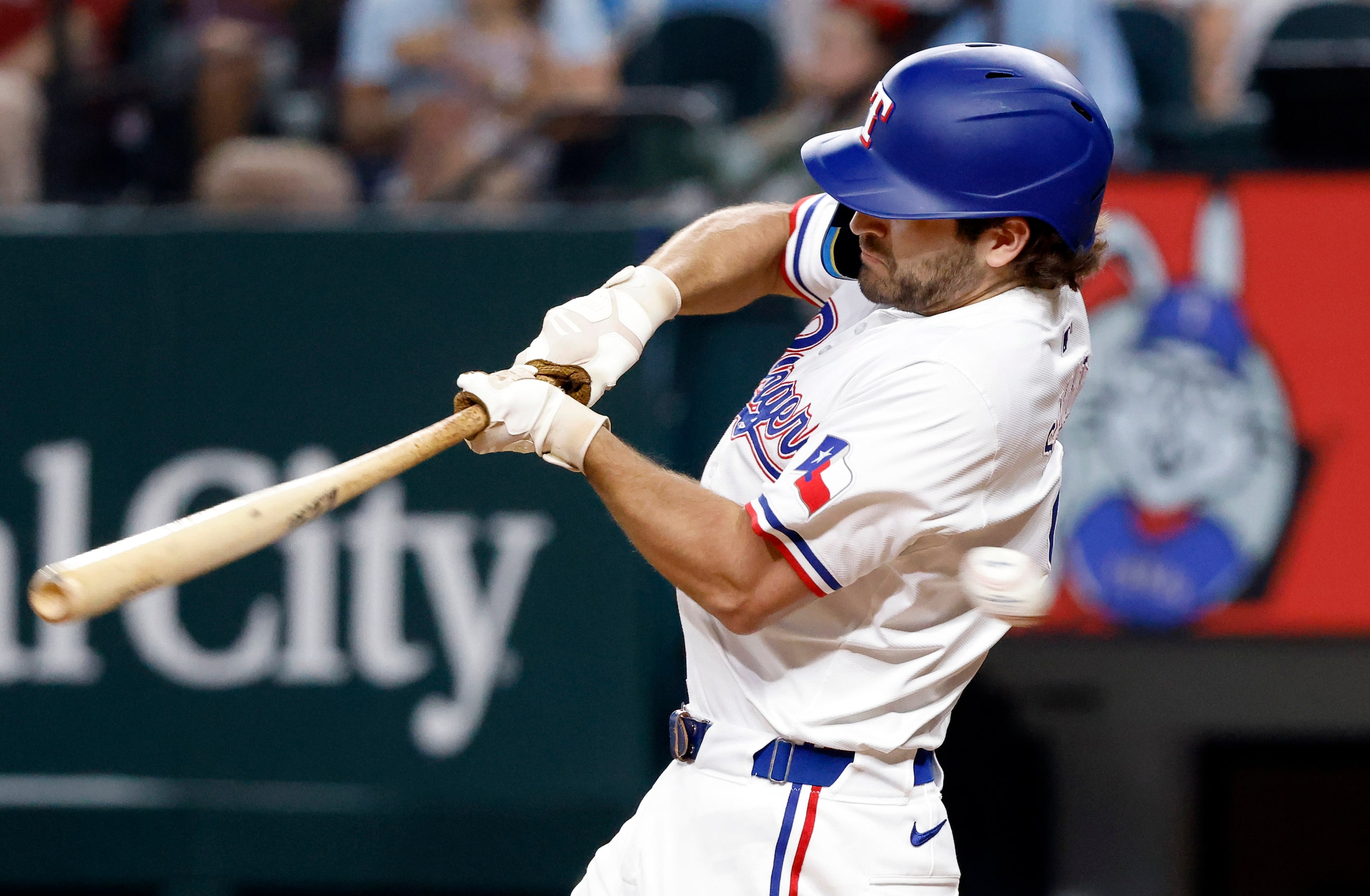 Texas Rangers batter Josh Smith swings and misses on a pitch by Baltimore Orioles pitcher...