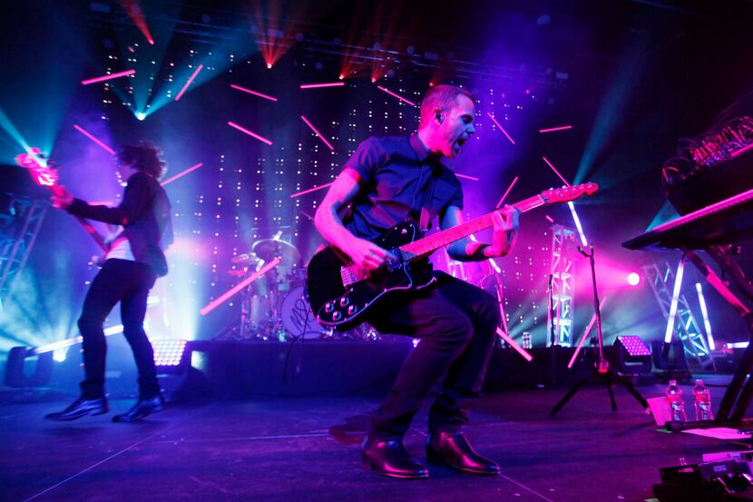 Anthony Gonzalez, right, leads the electronic music group M83 during their performance at...