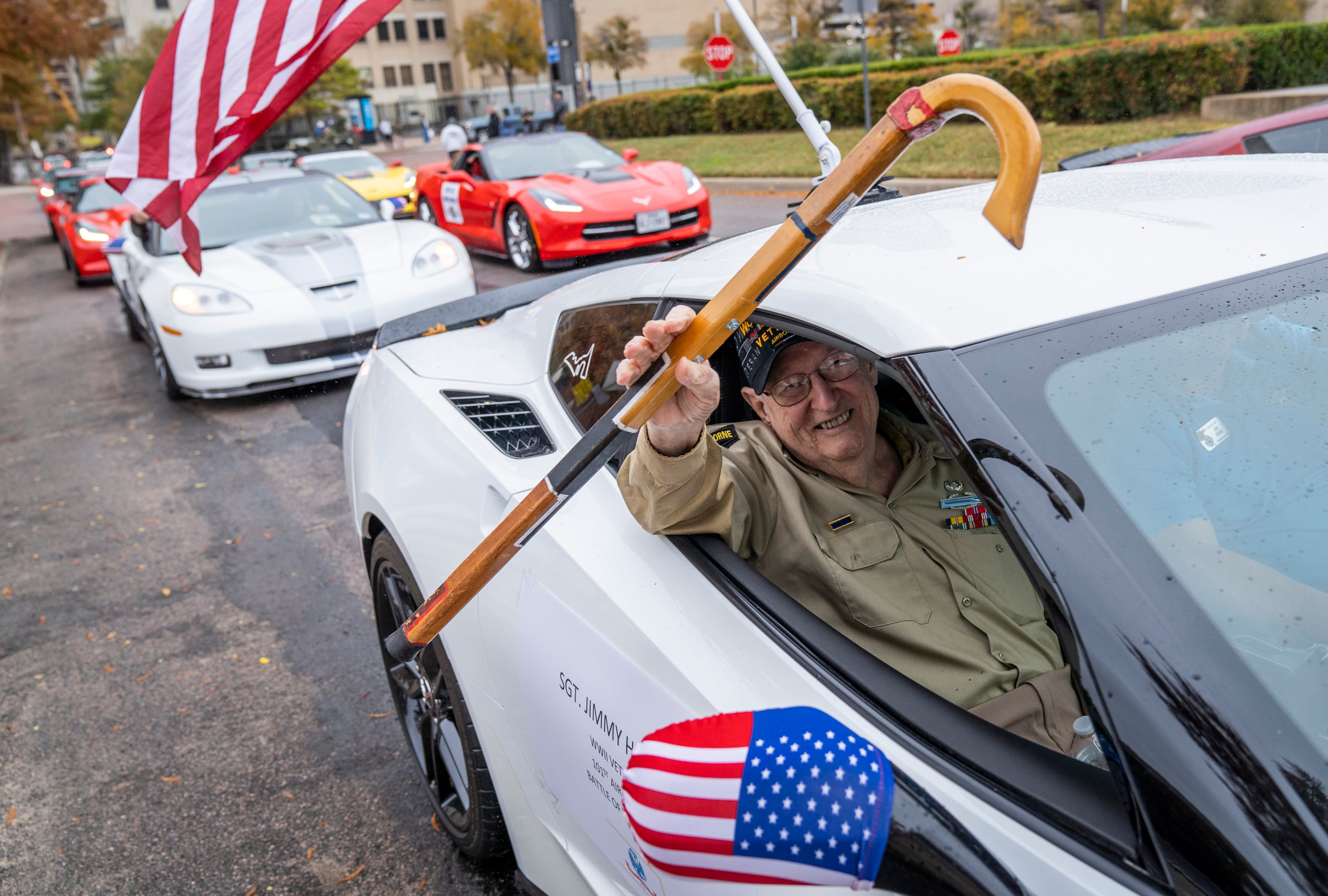 WWII veteran Jimmy Holmes waves from a Corvette during The Greater Dallas Veterans Day...