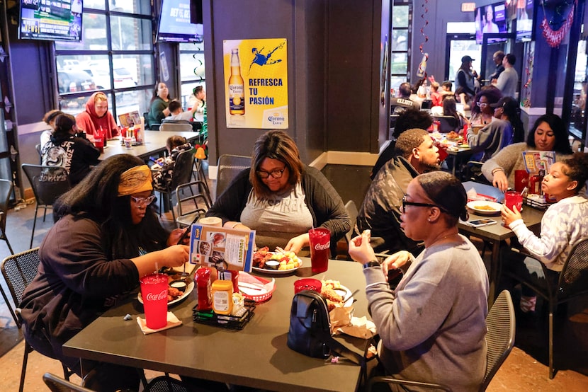 Karen Morris (center) sits with her daughter, Gabriella, (left), and her friend Kisha Voss...