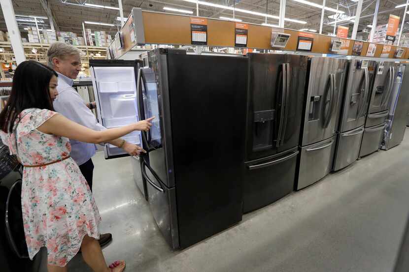 Shoppers examine refrigerators at a Home Depot store in Boston. On Wednesday, Oct. 16, the...