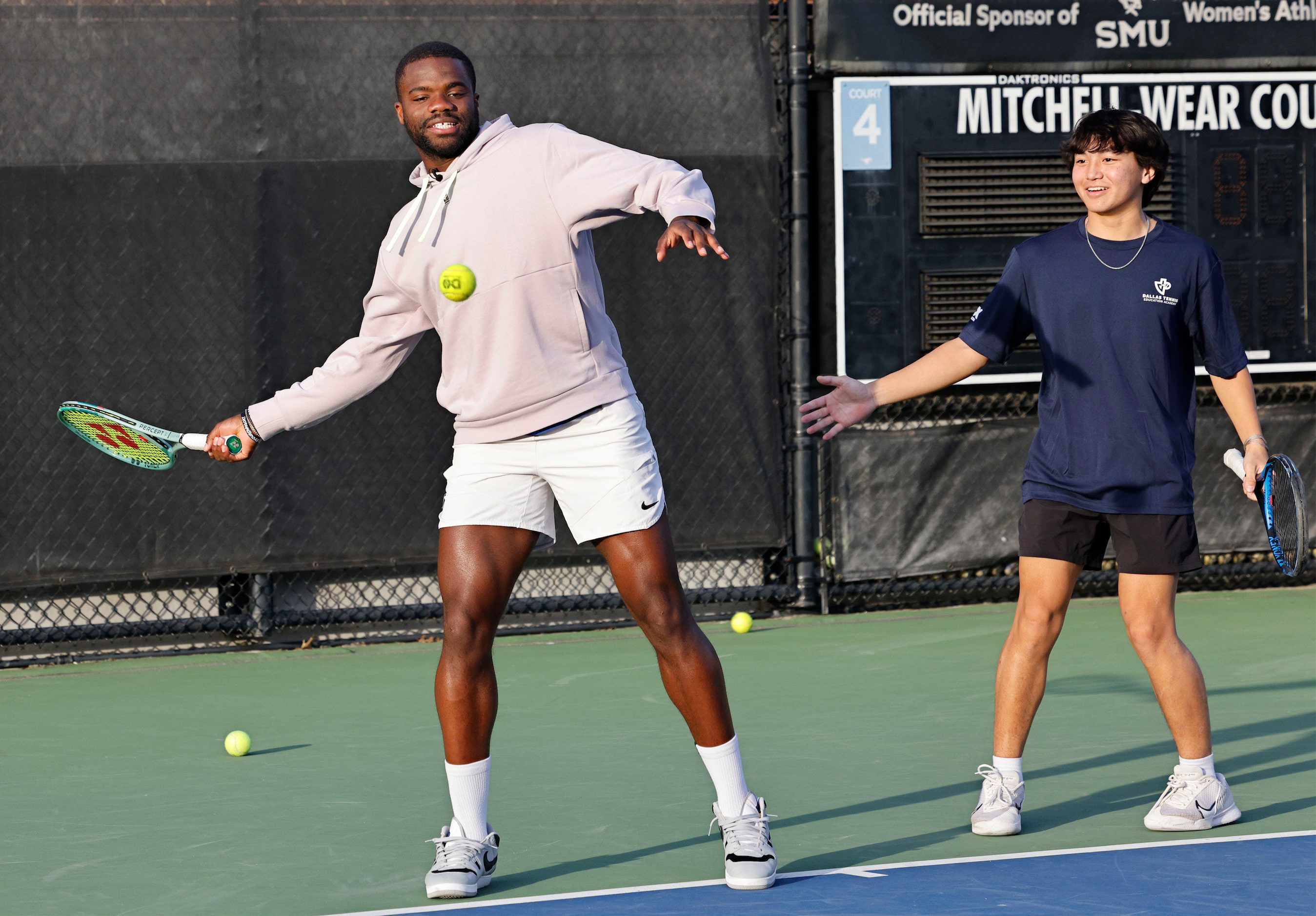 American tennis star Frances Tiafoe, left, plays tennis with Brady Lin, 16 of Dallas Tennis...